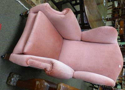 Lot 1258 - A wing armchair, upholstered in salmon fabric