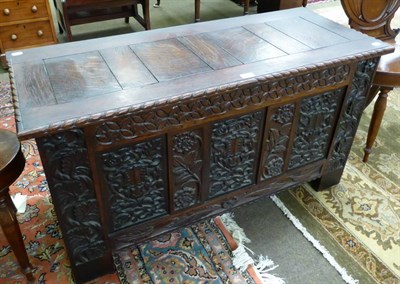 Lot 1301 - A 20th century carved oak blanket box