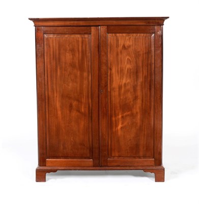 Lot 901 - A George III Mahogany Linen Press, circa 1800, the bold cornice above two cupboard doors...