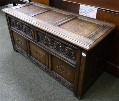 Lot 1309 - An oak blanket chest with carved decoration