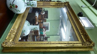 Lot 1348 - A large 18th/19th century gilded ornate picture frame with modern mirror plate