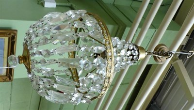 Lot 1349 - A brass and crystal 'bag' light fitting