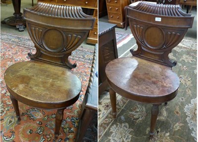 Lot 1353 - A pair of carved mahogany hall chairs, in the manner of Gillows, early 19th century, with gadrooned