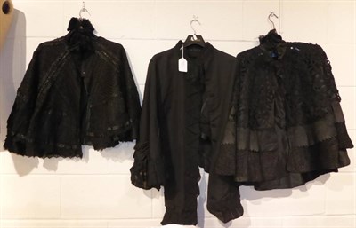 Lot 1374 - Victorian black silk cape with appliqued trim mount and silk lining; another with a black lace,...