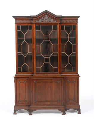 Lot 909 - A George III Style Mahogany Breakfront Bookcase, late 19th/early 20th century, with acanthus...