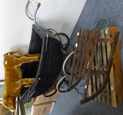 Lot 1419 - A Victorian pram, two vintage sledges and a large soft toy modelled as a calf