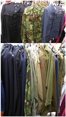 Lot 1423 - * A large quantity of assorted army khaki uniforms, police jackets, cotton khaki shirts and...