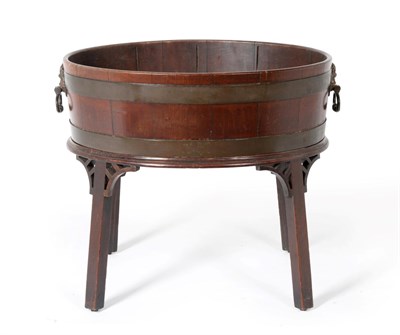 Lot 920 - A George III Mahogany and Brass Bound Oval Wine Cooler, circa 1800, of staved construction with...