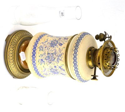 Lot 46 - An early 20th century pottery oil lamp with another glass chimney