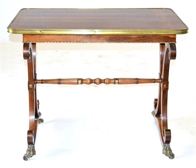 Lot 924 - A Regency Rosewood and Brass Mounted Library Table, early 19th century, of rounded rectangular...