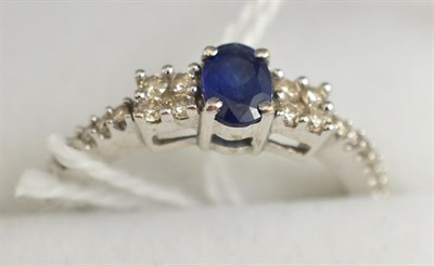 Lot 87 - An 18ct white gold sapphire and diamond ring