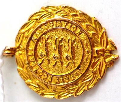 Lot 90 - A 9ct gold Jersey Football Association medal, one side worked with three lions enclosed by a laurel