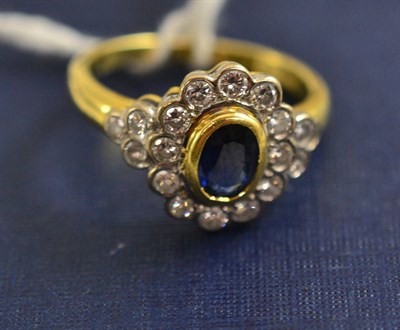 Lot 101 - An 18ct gold sapphire and diamond cluster ring, total estimated diamond weight 0.40 carat...