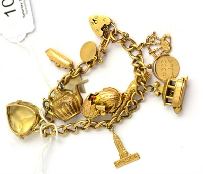 Lot 109 - A charm bracelet, hung with eleven charms including a heart shaped citrine and a 'Statue of...
