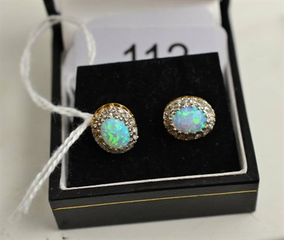 Lot 112 - A pair of opal and diamond cluster earrings