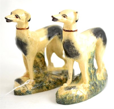 Lot 119 - A pair of greyhound figures on mossy decorated bases