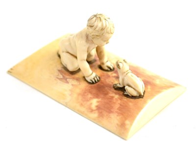 Lot 124 - A Continental ivory carving of a young child and a frog, early 20th century