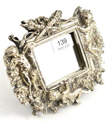 Lot 139 - A small mirror modelled with cherubs, stamped STERLING SILVER