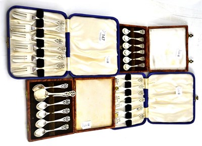 Lot 147 - Two cased sets of decorative silver teaspoons, two cased sets of silver cake forks and matching...