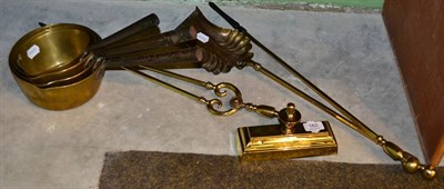 Lot 162 - Brass fire irons and four graduated sauce pans