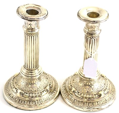 Lot 170 - A pair of George III silver candlesticks, maker's mark worn, Sheffield 1812 (later nozzles)