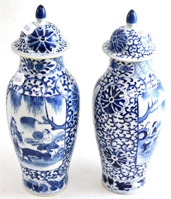 Lot 189 - A near pair of Chinese blue and white vases and covers
