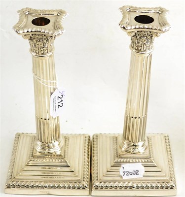 Lot 212 - A pair of silver Corinthian column table candlesticks, loaded
