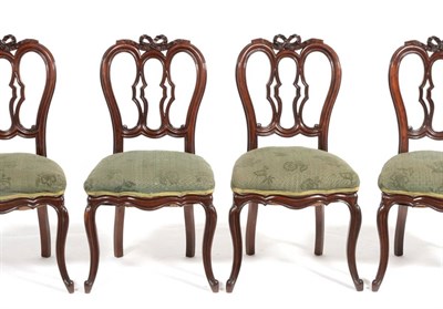 Lot 945 - A Set of Twelve Victorian Mahogany Dining Chairs, circa 1880, with ribbon tied top rails above...