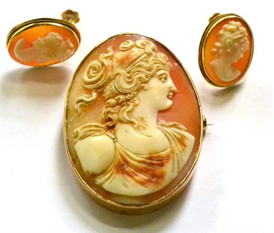 Lot 248 - A cameo brooch and a pair of screw on cameo earrings stamped '750'