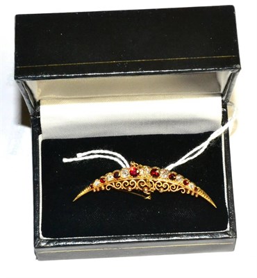 Lot 282 - A 15ct gold ruby and diamond crescent brooch
