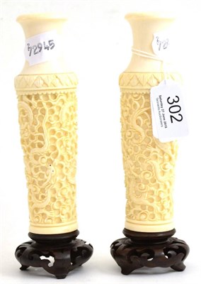 Lot 302 - A pair of 1920's ivory vases, carved with Chinese dragons