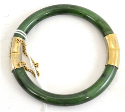 Lot 415 - A Spanish green jade bangle