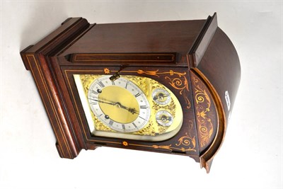 Lot 423 - A mahogany inlaid quarter striking mantel clock, movement stamped 'W & H Sch'