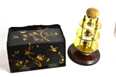 Lot 424 - A brass and mahogany bobbin holder with pin cushion and a black lacquered correspondence box