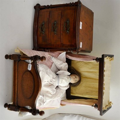 Lot 463 - A miniature half tester bed with drapes, a miniature chest of drawers and a modern doll