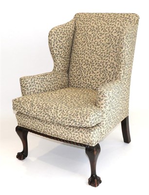 Lot 983 - A George III Style Wing-Back Armchair, late 19th century, recovered in cream and green foliate...