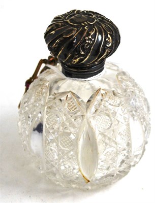 Lot 494 - A silver mounted perfume bottle and three brooches