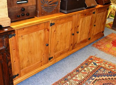 Lot 1008 - A modern pine dresser base with four cupboards