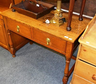 Lot 1043 - An early 20th century oak side table, with two frieze drawers, on turned legs