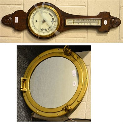 Lot 1135 - A carved oak wheel barometer and brass mounted ship's mirror