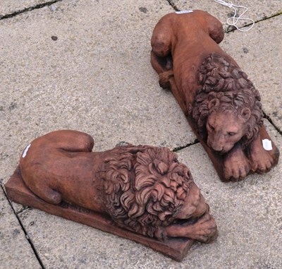 Lot 1159 - Pair of terracotta lions, after originals by Canova, 45cm long