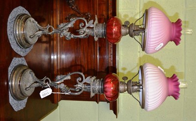 Lot 1189 - A pair of Victorian oil lamps with cranberry shades