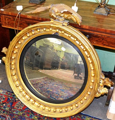 Lot 1197 - A 19th century gilt framed circular convex wall mirror with eagle mount