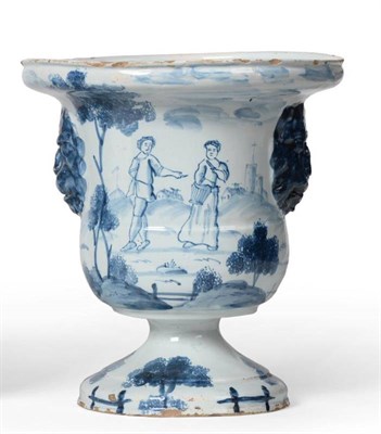 Lot 24 - An English Delft Urn, probably London, circa 1760, of bell shape with lion's mask handles on a...