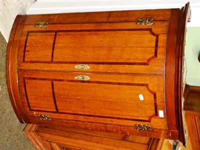 Lot 1209 - A Georgian oak bow front corner cabinet with mahogany inlay