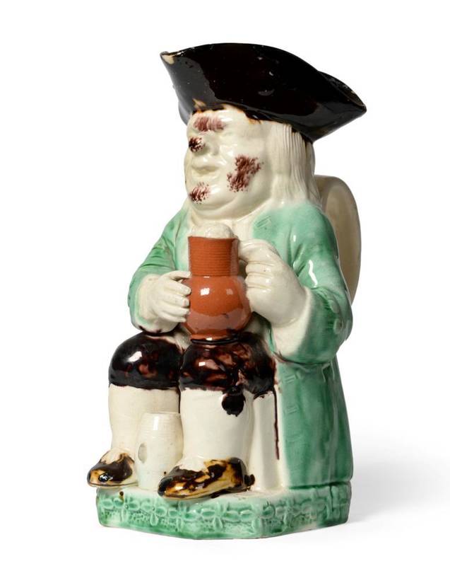 Lot 26 - A Ralph Wood Type Toby Jug, circa 1780, of traditional form with manganese hat and green jacket...