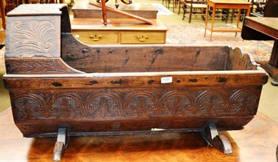 Lot 1227 - A carved oak cradle