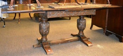 Lot 1302 - Carved oak draw leaf table