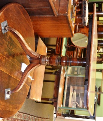 Lot 1310 - A George III mahogany flip top tripod table, raised on a turned support, with three splayed legs