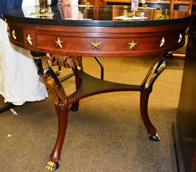 Lot 1317 - An Egyptian revival mahogany and parcel gilt centre table, of recent date, with black slate...